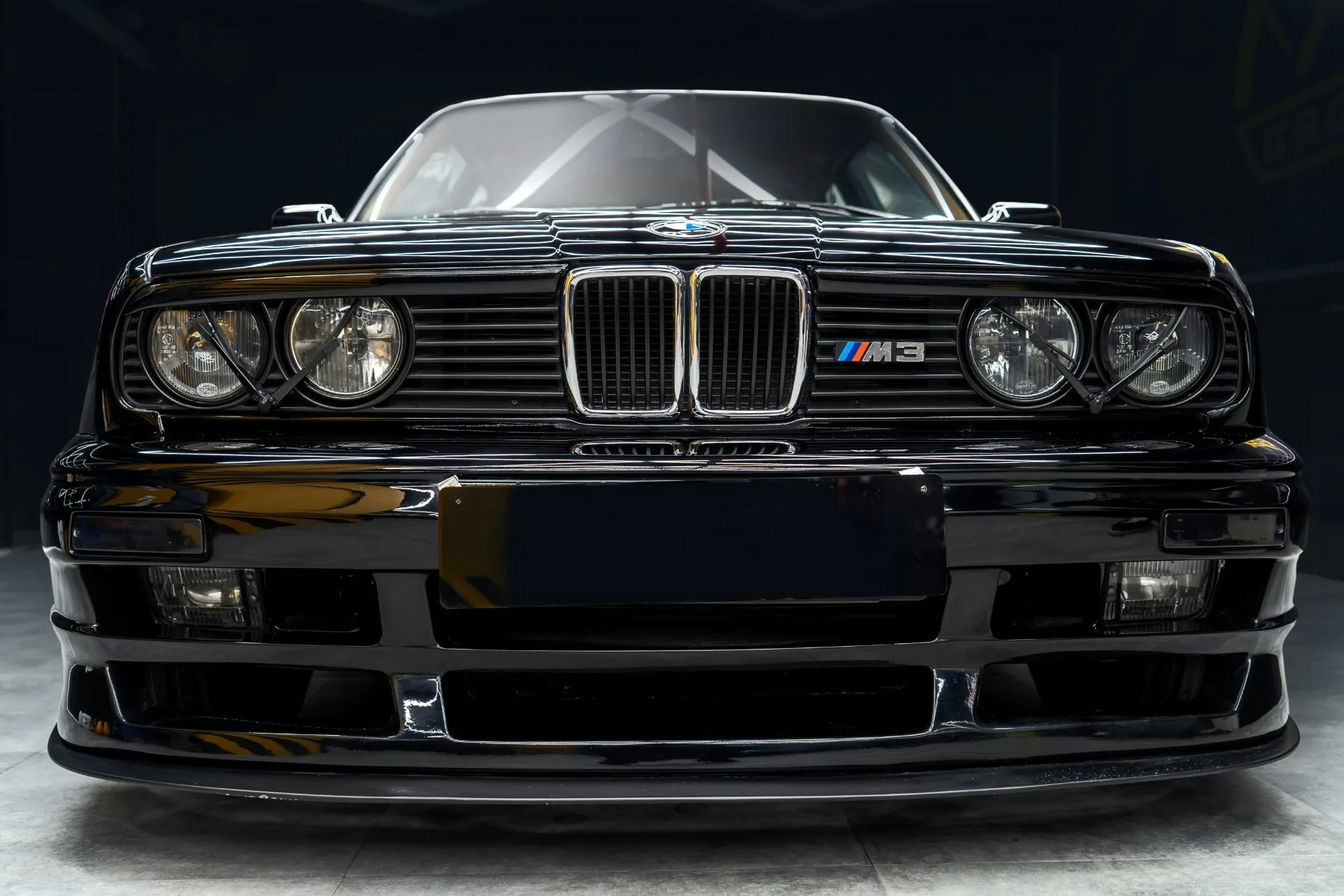 Black BMW E30 M3 front end in a studio
